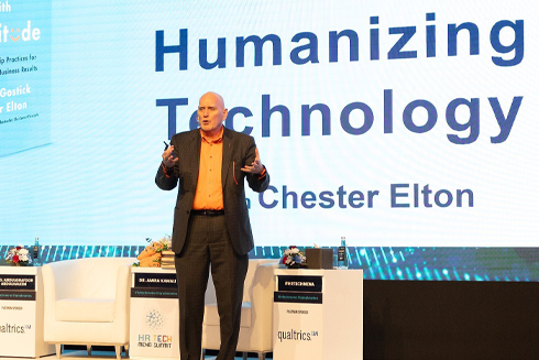 Remarkable Speakers Bureau Chester Elton onstage humanizing technology