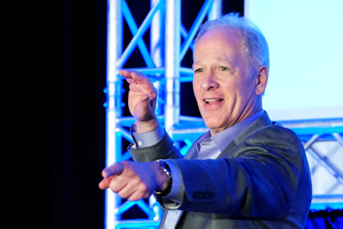 Bill Stainton onstage pointing